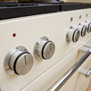 Modern kitchen cooker. Large range style cooker in modern kitchen interior with granite worktop and cream units